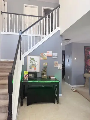 a staircase with a green table in a hallway at Poconos home away from home in East Stroudsburg