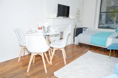 a room with a table and chairs and a bed at Stylish2 Upper West Side Apartment 5-Min Walk to Central Park in New York