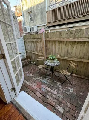 a patio with a table and chairs and a fence at Charming Trinity in Center City, Philadelphia in Philadelphia