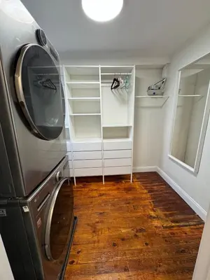 a laundry room with a refrigerator and wooden floors at Charming Trinity in Center City, Philadelphia in Philadelphia