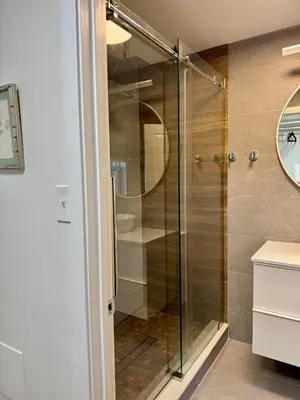 a shower with a glass door in a bathroom at Charming Trinity in Center City, Philadelphia in Philadelphia
