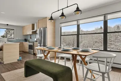 a kitchen and dining room with a table and chairs at Cozy Creekside Retreat - Minutes to Delhi & Andes in De Lancey