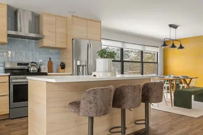 a kitchen with a counter with two bar stools at Cozy Creekside Retreat - Minutes to Delhi & Andes in De Lancey