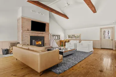 a living room with a couch and a fireplace at Cozy Creekside Retreat - Minutes to Delhi & Andes in De Lancey