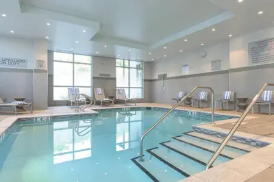 a swimming pool with stairs in a building at Courtyard by Marriott Edgewater NYC Area in Edgewater