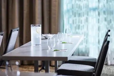a table with wine glasses and a lemon on it at Courtyard by Marriott Edgewater NYC Area in Edgewater