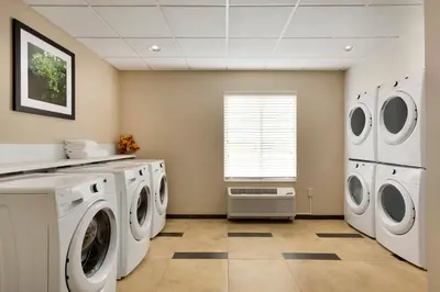 a laundry room with washing machines and a window at Candlewood Suites Vestal - Binghamton by IHG in Vestal