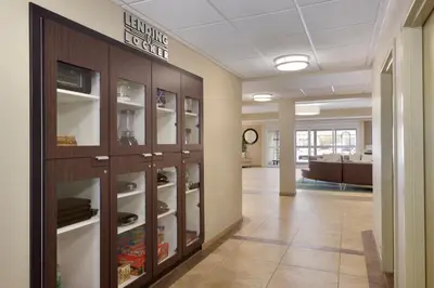 a hallway in a office with glass cabinets at Candlewood Suites Vestal - Binghamton by IHG in Vestal