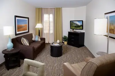 a living room with a couch and a tv at Candlewood Suites Vestal - Binghamton by IHG in Vestal
