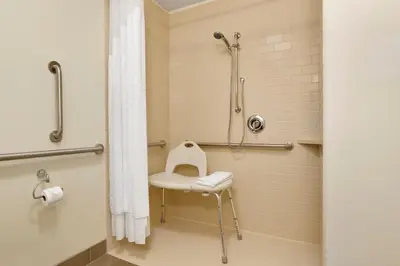 a bathroom with a shower with a toilet and a sink at Candlewood Suites Vestal - Binghamton by IHG in Vestal