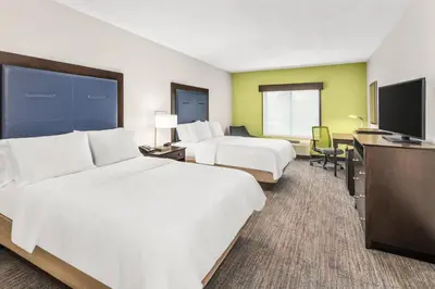 a hotel room with two beds and a flat screen tv at Holiday Inn Express & Suites Wilmington-Newark by IHG in Newark