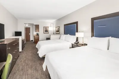 a hotel room with two beds and a desk at Holiday Inn Express & Suites Wilmington-Newark by IHG in Newark