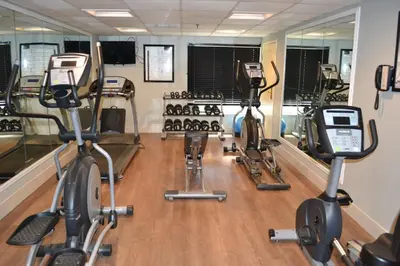 a gym with several exercise bikes and mirrors at Holiday Inn Express Harrisburg SW - Mechanicsburg by IHG in Mechanicsburg