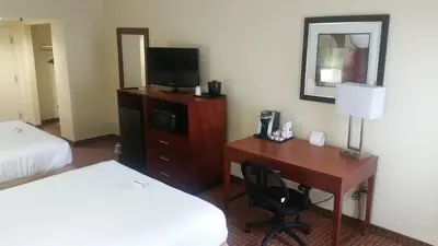 a hotel room with a desk and a bed and a television at Holiday Inn Express Harrisburg SW - Mechanicsburg by IHG in Mechanicsburg