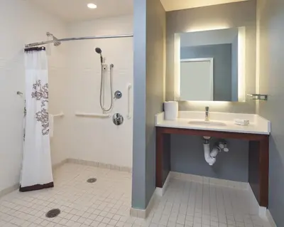 a bathroom with a sink and a shower with a mirror at Residence Inn by Marriott Philadelphia Airport in Philadelphia