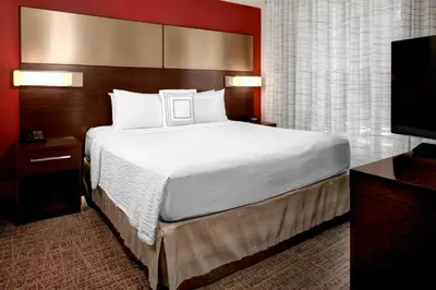 a bedroom with a large bed and a flat screen tv at Residence Inn by Marriott Philadelphia Airport in Philadelphia