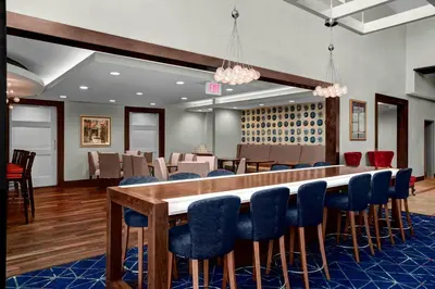 a dining room with a long table and blue chairs at Residence Inn by Marriott Philadelphia Airport in Philadelphia