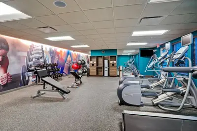 a gym with treadmills and cardio machines at Residence Inn by Marriott Hamilton in Hamilton