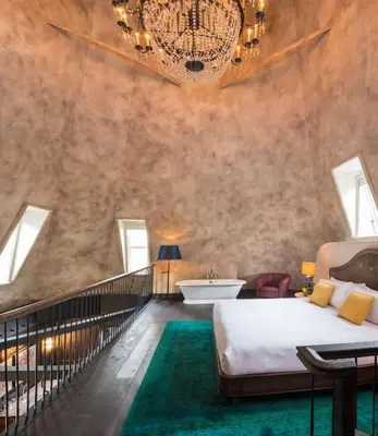 a bedroom with a large bed and a bath tub at The Beekman, A Thompson Hotel, by Hyatt in New York