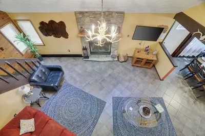 an overhead view of a living room with a chandelier at Chalet renovated Near Casino, Camelback , Kalahari 4bdrms firepit hot tub game room in Tobyhanna