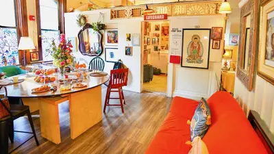 a living room with a red couch and a table at Interfaith Retreats in New York