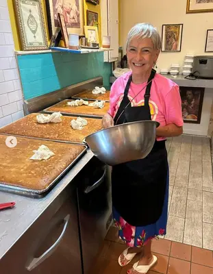 a woman standing in a kitchen holding a bowl at Interfaith Retreats in New York