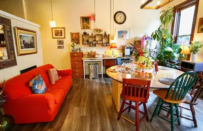a living room with a red couch and a table at Interfaith Retreats in New York