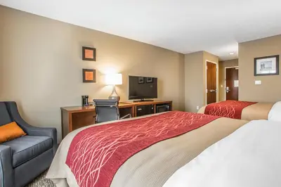 a hotel room with a bed and a tv at Comfort Inn PA Turnpike - I-81 in Carlisle