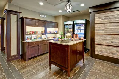 a large kitchen with a counter and a refrigerator at Homewood Suites by Hilton Bridgewater/Branchburg in Branchburg Park