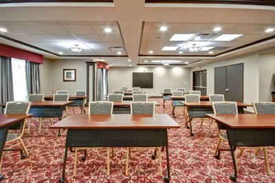a conference room with tables and chairs and a chalkboard at Homewood Suites by Hilton Bridgewater/Branchburg in Branchburg Park