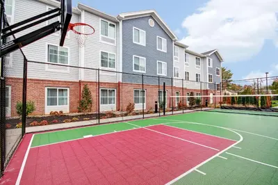 a tennis court with a basketball hoop in front of a building at Homewood Suites by Hilton Bridgewater/Branchburg in Branchburg Park