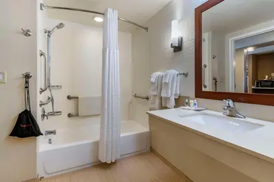 a bathroom with a tub and a sink and a shower at Comfort Suites Manheim - Lancaster in Manheim