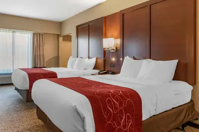 two beds in a hotel room with white sheets at Comfort Suites Manheim - Lancaster in Manheim