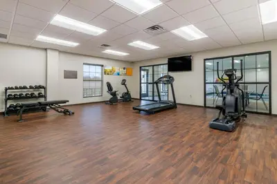 a gym with treadmills and exercise bikes in a room at Comfort Suites Manheim - Lancaster in Manheim