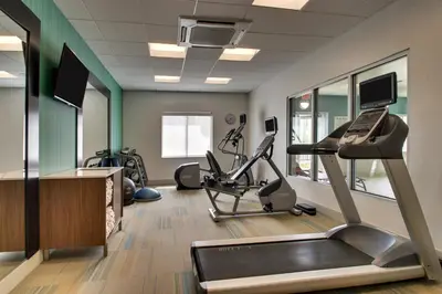 a gym with exercise bikes and a treadmill at Holiday Inn Express & Suites Lancaster East - Strasburg by IHG in Strasburg