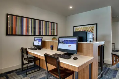 a desk with two monitors and a computer on it at Holiday Inn Express & Suites Lancaster East - Strasburg by IHG in Strasburg