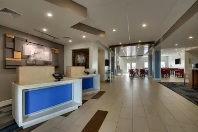 an office lobby with a hallway with blue at Holiday Inn Express & Suites Lancaster East - Strasburg by IHG in Strasburg