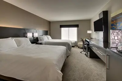 a hotel room with two beds and a flat screen tv at Holiday Inn Express & Suites Lancaster East - Strasburg by IHG in Strasburg