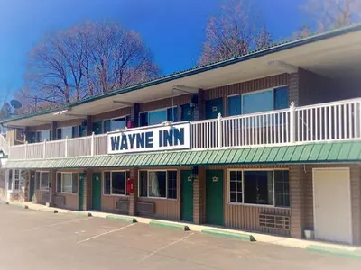 a building with a sign that reads wave inn at Wayne Inn in Honesdale