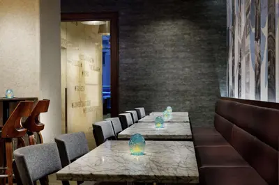 a row of tables and chairs in a restaurant at Distrikt Hotel New York City, Tapestry Collection by Hilton in New York