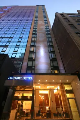 a tall building with a sign that reads district hotel at Distrikt Hotel New York City, Tapestry Collection by Hilton in New York