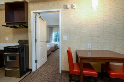 a kitchen with a table and a room with a bed at Residence Inn by Marriott Philadelphia Great Valley/Malvern in Malvern