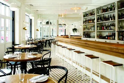 a restaurant with tables and chairs and a bar at The Standard, High Line New York in New York