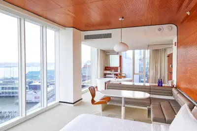 a living room with a couch and a table at The Standard, High Line New York in New York