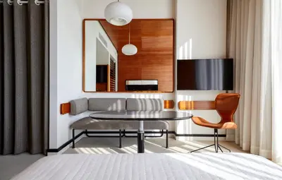 a living room with a table and a couch at The Standard, High Line New York in New York