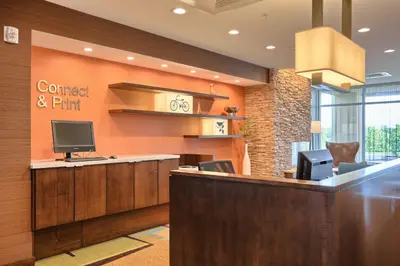 a lobby with a desk with a computer on the wall at Fairfield by Marriott Inn & Suites Philadelphia Horsham in Willow Grove