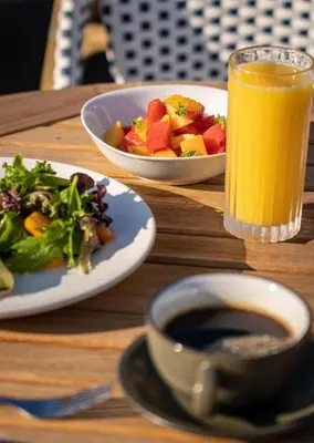 a table with two plates of food and a glass of orange juice at DoubleTree by Hilton Fairfield Hotel & Suites in Fairfield