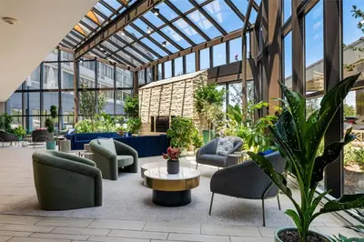 a conservatory with chairs and tables and plants at DoubleTree by Hilton Fairfield Hotel & Suites in Fairfield