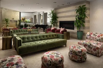 a living room with green couches and a piano at DoubleTree by Hilton Fairfield Hotel & Suites in Fairfield