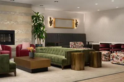 a living room with a green couch and chairs at DoubleTree by Hilton Fairfield Hotel & Suites in Fairfield